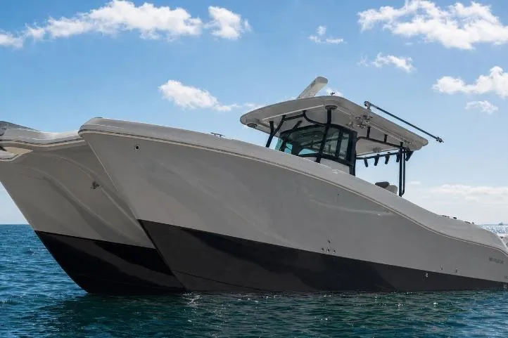 Slide: The Image of 2020 World Cat 325 CC boat on open water under blue sky. - 4
