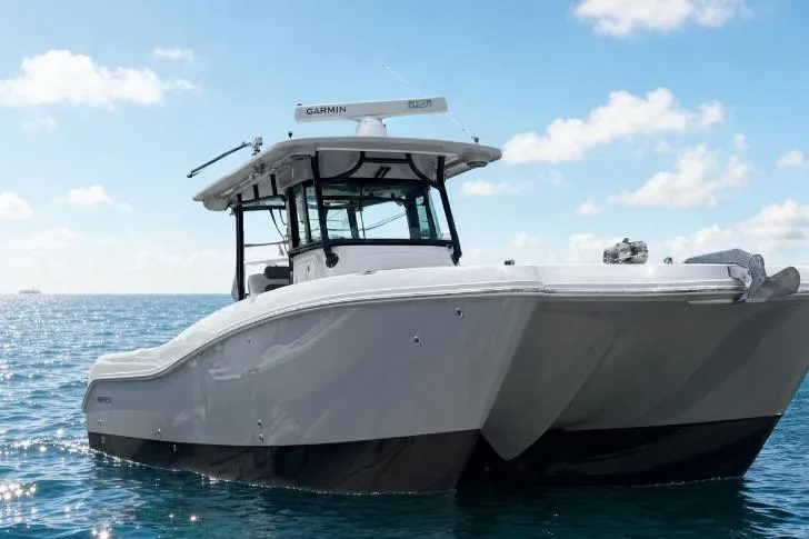 Slide: The Image of 2020 World Cat 325 CC boat on open water under a clear sky. - 5