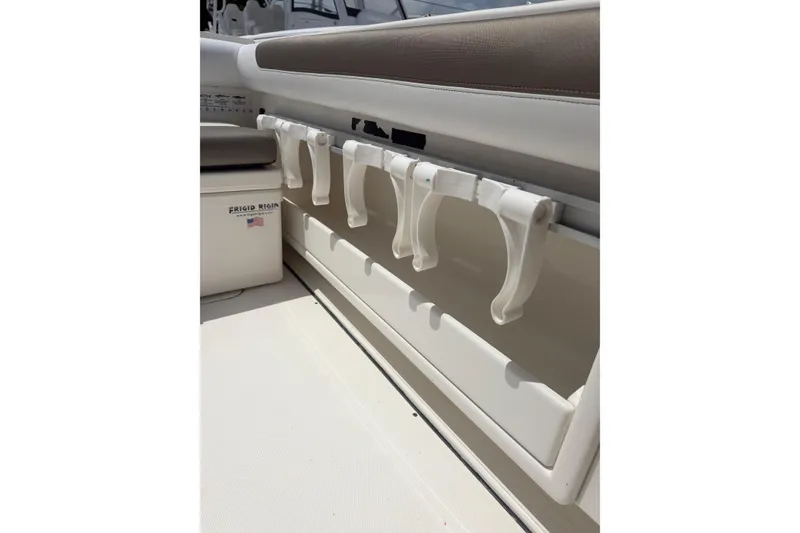 Slide: The Image of 2020 World Cat 325 CC boat interior with rod holders and storage compartment. - 8