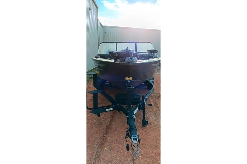 Slide: The Image of 2025 Ranger VX1788 WT boat on trailer, parked outdoors near a building. - 10