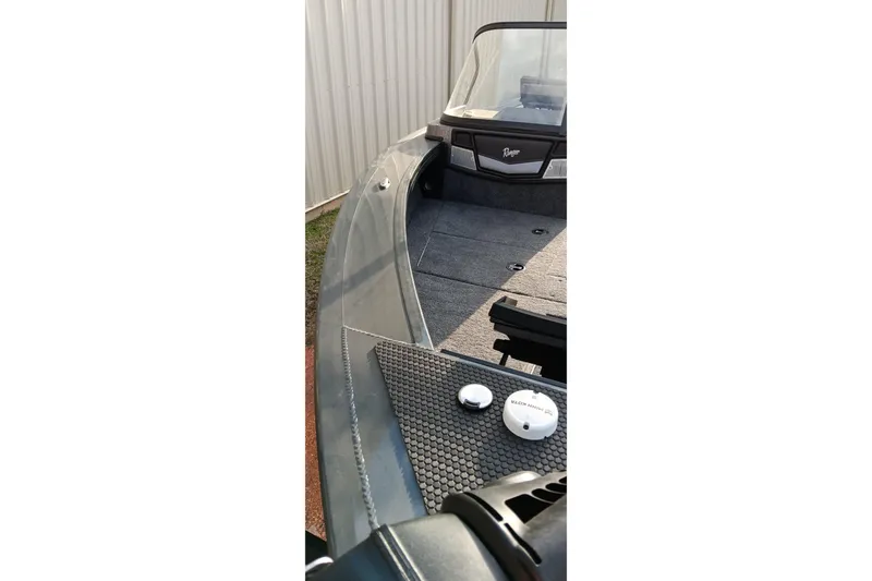 Slide: The Image of 2025 Ranger VX1788 WT boat interior with windshield and deck details. - 12