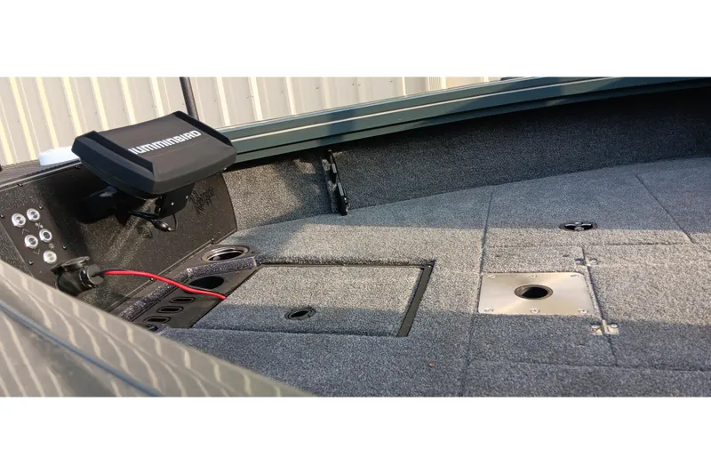 Slide: The Image of 2025 Ranger VX1788 WT boat interior with Humminbird electronics and carpeted deck. - 13