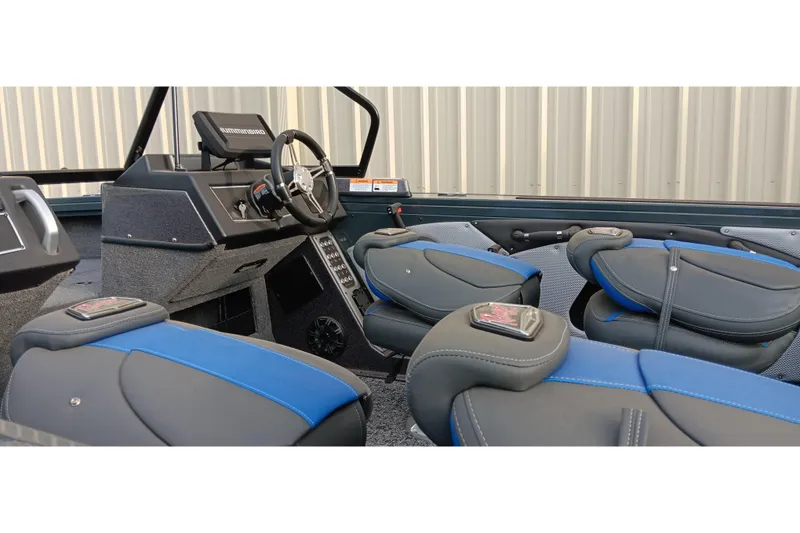 Slide: The Image of 2025 Ranger VX1788 WT boat interior with blue and gray seating, steering wheel, and controls. - 16