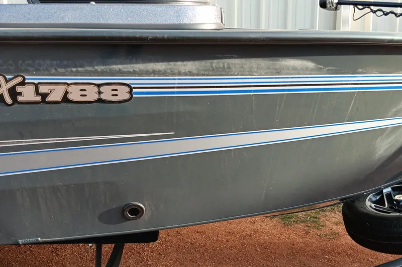 Slide: The Image of 2025 Ranger VX1788 WT boat with blue and white stripes on the side. - 2