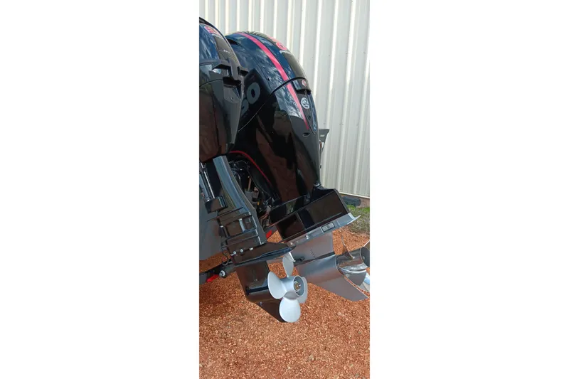 Slide: The Image of 2025 Ranger VX1788 WT boat motor with dual propellers, parked on gravel. - 20