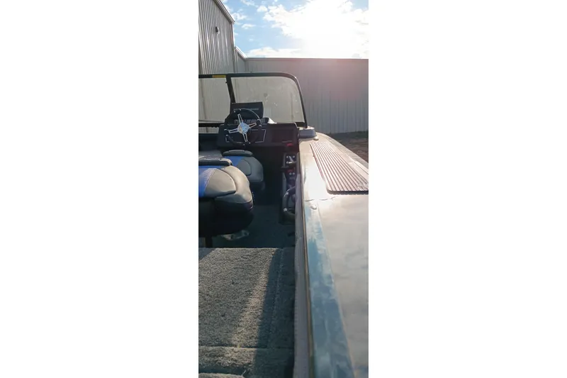 Slide: The Image of 2025 Ranger VX1788 WT boat interior with steering wheel and seating, under bright sunlight. - 6