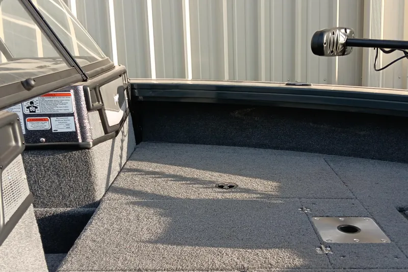 Slide: The Image of Interior view of a 2025 Ranger VX1788 WT boat, showcasing carpeted deck and storage compartments. - 9