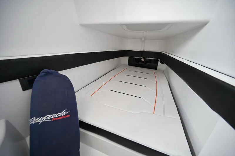 Slide: The Image of Interior cabin of 2027 Renegade 38' Open boat, featuring sleek white and black design. - 14