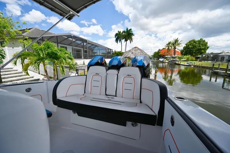 Slide: The Image of Renegade 38' Open 2027 boat interior with dual engines, docked by a scenic canal. - 23