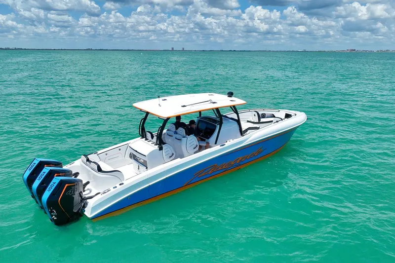 Slide: The Image of 2027 Renegade 38' Open boat on turquoise water under a cloudy sky. - 27