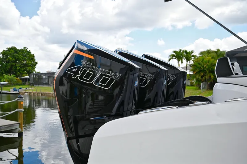 Slide: The Image of Renegade 38' Open 2027 boat with triple Racing 400 engines docked by water. - 6