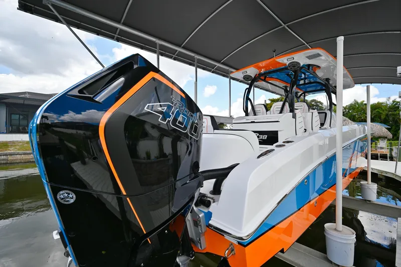 Slide: The Image of 2027 Renegade 38' Open boat with powerful outboard engine, docked under canopy. - 8