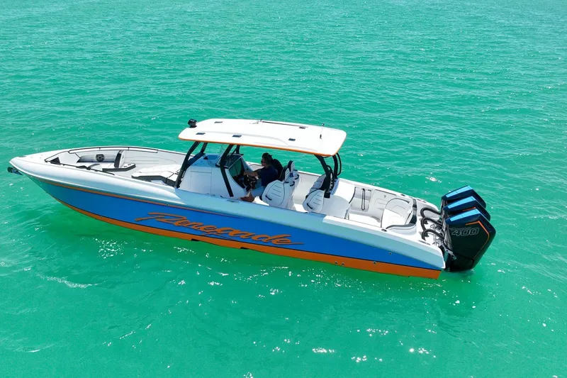 Slide: The Image of 2027 Renegade 38' Open boat on turquoise water, featuring sleek design and powerful engines. - 9