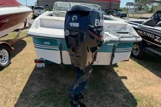Slide: The Image of 1995 Four Winns 170 Freedom OB boat with Evinrude outboard motor, parked on grass. - 3