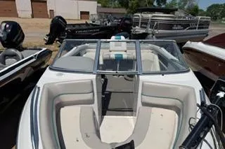 Slide: The Image of 1995 Four Winns 170 Freedom OB boat with open bow seating, docked outdoors. - 5