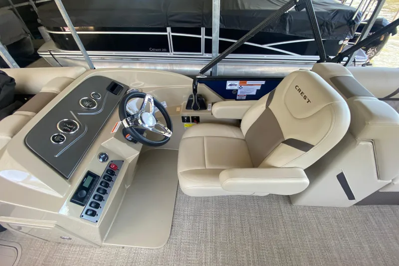 Slide: The Image of 2023 Crest Classic DLX 240 SLC boat interior with steering wheel and control panel. - 17