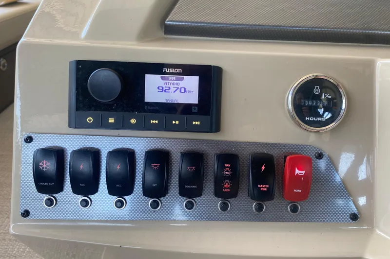 Slide: The Image of Control panel of 2023 Crest Classic DLX 240 SLC with radio and switches. - 18