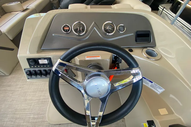 Slide: The Image of Steering console of 2023 Crest Classic DLX 240 SLC boat with modern controls and gauges. - 21