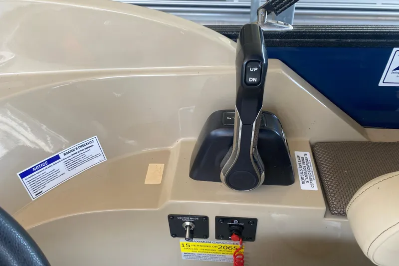Slide: The Image of Control panel of 2023 Crest Classic DLX 240 SLC boat with throttle lever and safety notices. - 22