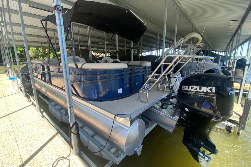 Slide: The Image of 2023 Crest Classic DLX 240 SLC pontoon boat with Suzuki outboard motor docked. - 3