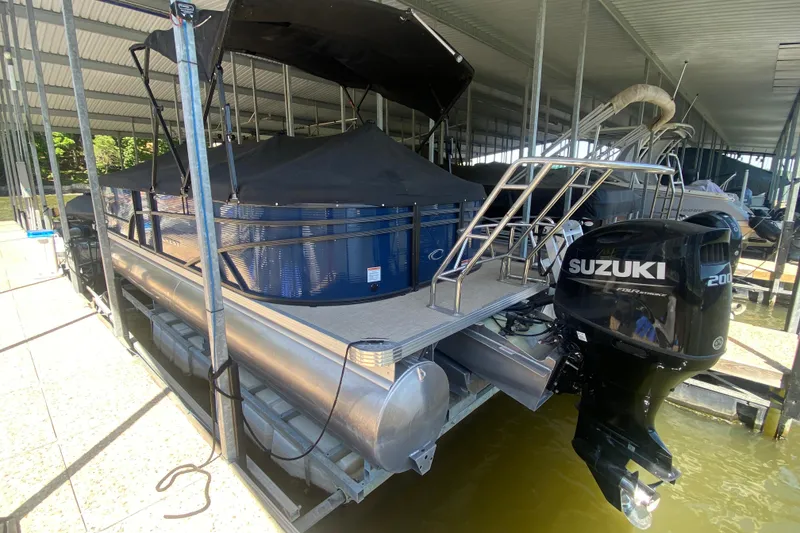 Slide: The Image of 2023 Crest Classic DLX 240 SLC pontoon boat with Suzuki outboard motor in dock. - 30