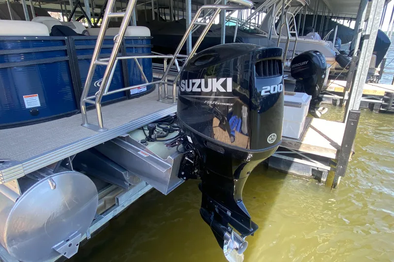 Slide: The Image of 2023 Crest Classic DLX 240 SLC pontoon with Suzuki 200 outboard motor at dock. - 4