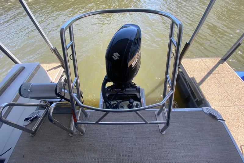 Slide: The Image of 2023 Crest Classic DLX 240 SLC boat with Suzuki outboard motor on water. - 7