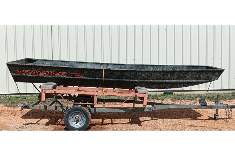 The Image of 2026 Tracker Topper 1542 LW Riveted Jon boat on trailer, parked outdoors. - 0