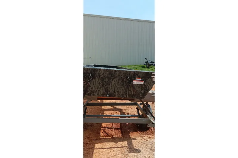 Slide: The Image of 2026 Tracker Topper 1542 LW Riveted Jon boat on trailer, outdoors. - 14