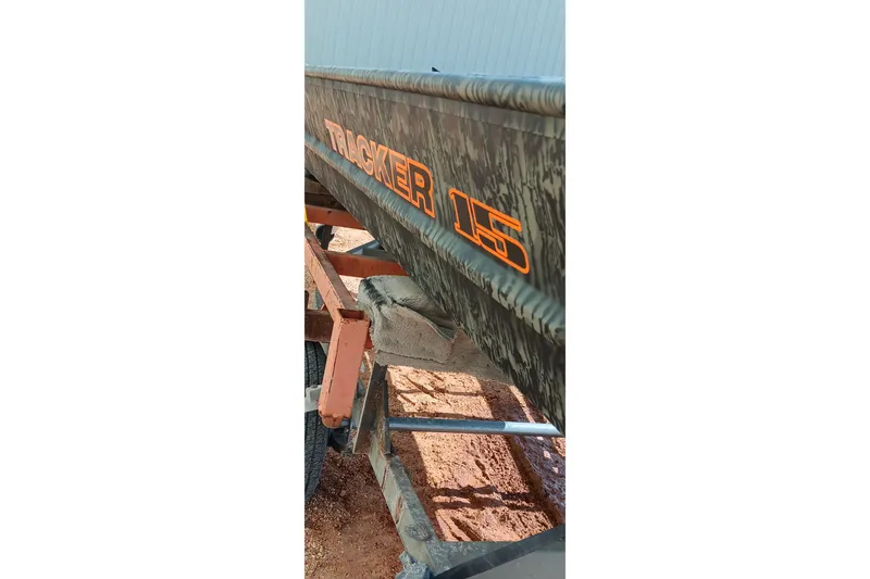 Slide: The Image of 2026 Tracker Topper 1542 LW Riveted Jon boat on trailer, camo design. - 16