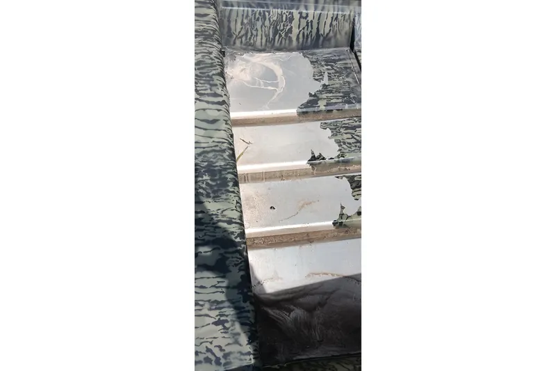 Slide: The Image of Interior view of 2026 Tracker Topper 1542 LW Riveted Jon boat with camouflage pattern. - 18