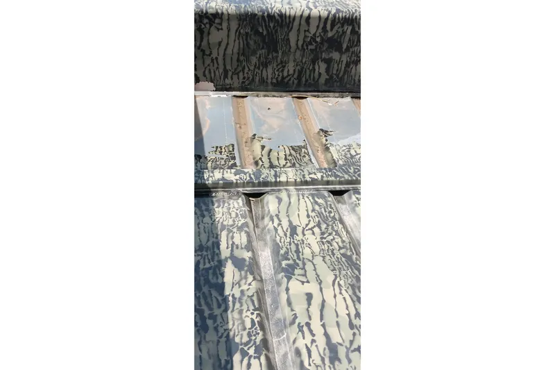 Slide: The Image of Interior view of 2026 Tracker Topper 1542 LW Riveted Jon boat with camouflage pattern. - 2