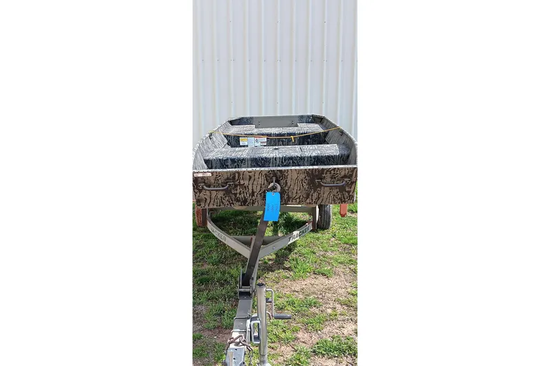 Slide: The Image of 2026 Tracker Topper 1542 LW Riveted Jon boat on trailer, camo design. - 3