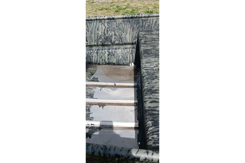 Slide: The Image of Interior of 2026 Tracker Topper 1542 LW Riveted Jon boat with camouflage pattern. - 5