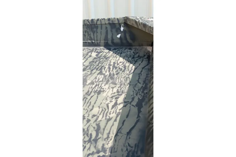 Slide: The Image of 2026 Tracker Topper 1542 LW Riveted Jon boat with camouflage pattern detail. - 6