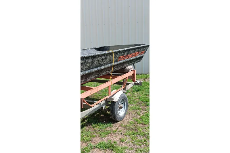 Slide: The Image of 2026 Tracker Topper 1542 LW Riveted Jon boat on trailer, outdoors. - 7