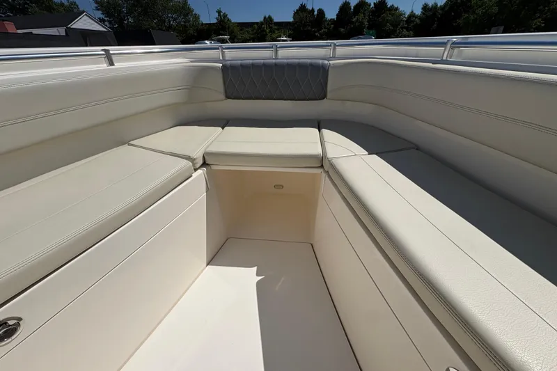 Slide: The Image of 2018 Cobia 277 Center Console boat interior with cushioned seating and sleek design. - 10