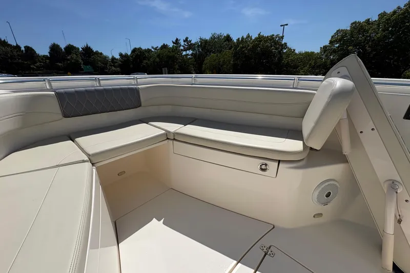 Slide: The Image of 2018 Cobia 277 Center Console boat interior with cushioned seating and storage. - 11