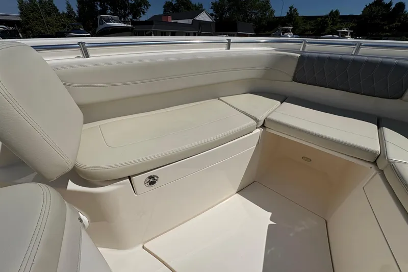 Slide: The Image of 2018 Cobia 277 Center Console boat interior with cushioned seating and storage. - 12