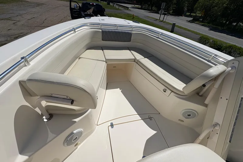 Slide: The Image of 2018 Cobia 277 Center Console boat interior with cushioned seating and railings. - 14