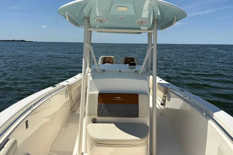 Slide: The Image of 2018 Cobia 277 Center Console boat on open water, featuring sleek design and spacious deck. - 22