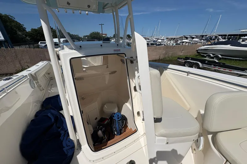Slide: The Image of 2018 Cobia 277 Center Console boat interior with open storage compartment and seating. - 23