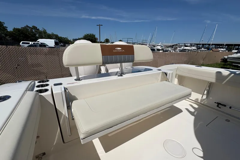 Slide: The Image of 2018 Cobia 277 Center Console boat interior with seating and cup holders. - 24