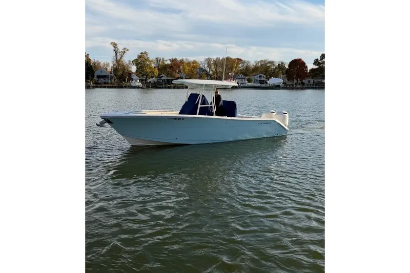 Slide: The Image of 2018 Cobia 277 Center Console boat cruising on a calm lake. - 3