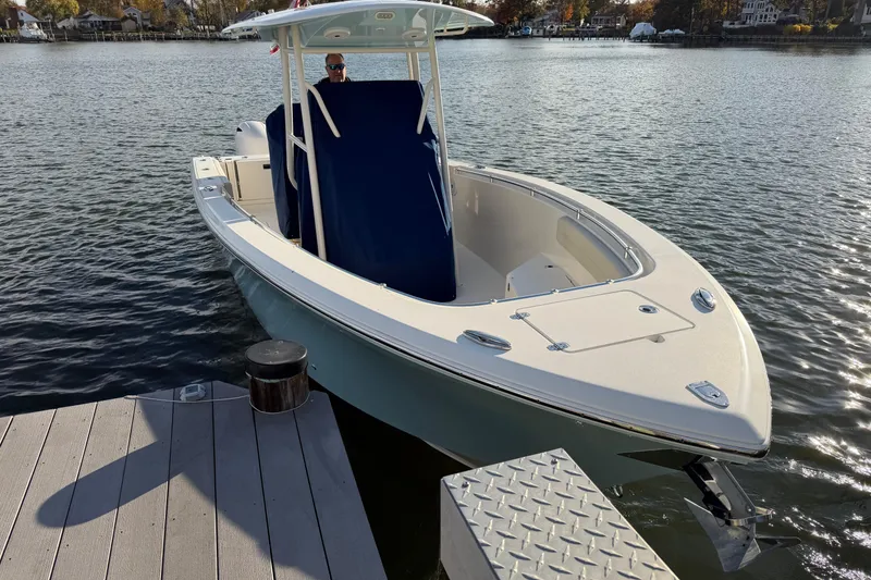 Slide: The Image of 2018 Cobia 277 Center Console boat docked on a sunny day. - 4