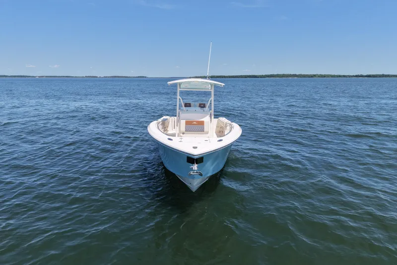 Slide: The Image of 2018 Cobia 277 Center Console boat on calm blue water under clear sky. - 5