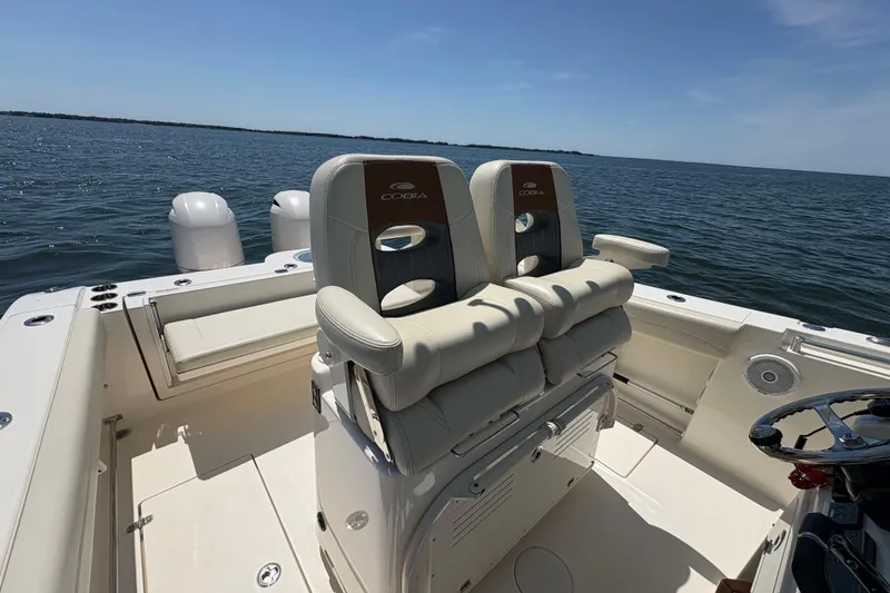 Slide: The Image of 2018 Cobia 277 Center Console boat interior with dual seats, ocean view. - 7