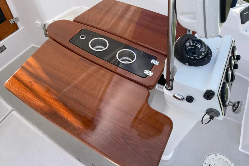 Slide: The Image of Cockpit of 2014 Catalina 355 sailboat with wooden table and navigation instruments. - 10