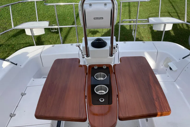 Slide: The Image of Cockpit of 2014 Catalina 355 sailboat with wooden table and stainless steel cup holders. - 11