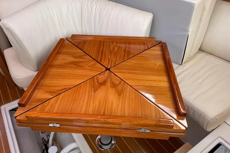 Slide: The Image of Wooden table on a 2014 Catalina 355 yacht, surrounded by white seating. - 12